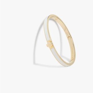 Kate Spade white logo bracelet with gold details. Barely worn.